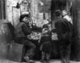 USA: Chinese man with queue and three children at a roadside toy stall, San Francisco Chinatown, c. 1900